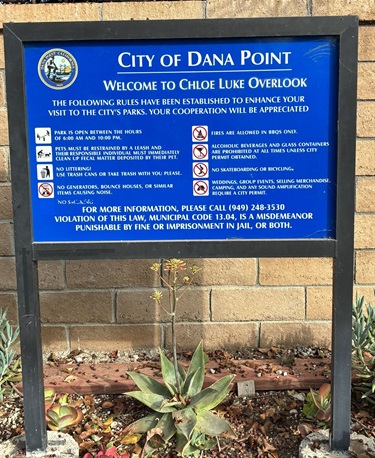 City of Dana Point rules sign at Chloe Luke Overlook displaying visitor guidelines and park regulations.